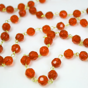 Chain 100 cm Ø 10 mm faceted orange crystal beads, bright brass-plated eyelet pin.